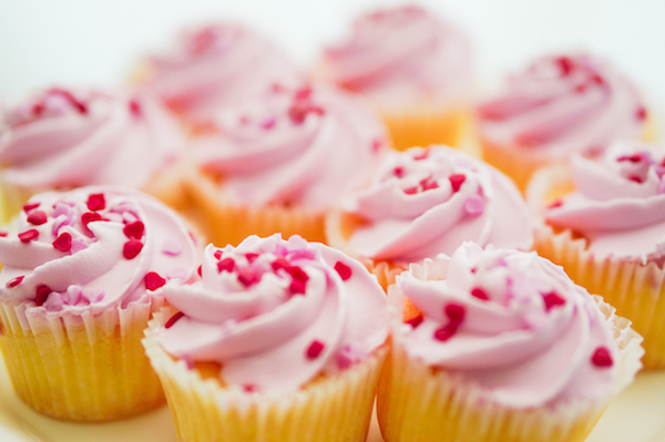 Cupcakes with pink cream and heart sprinkles
