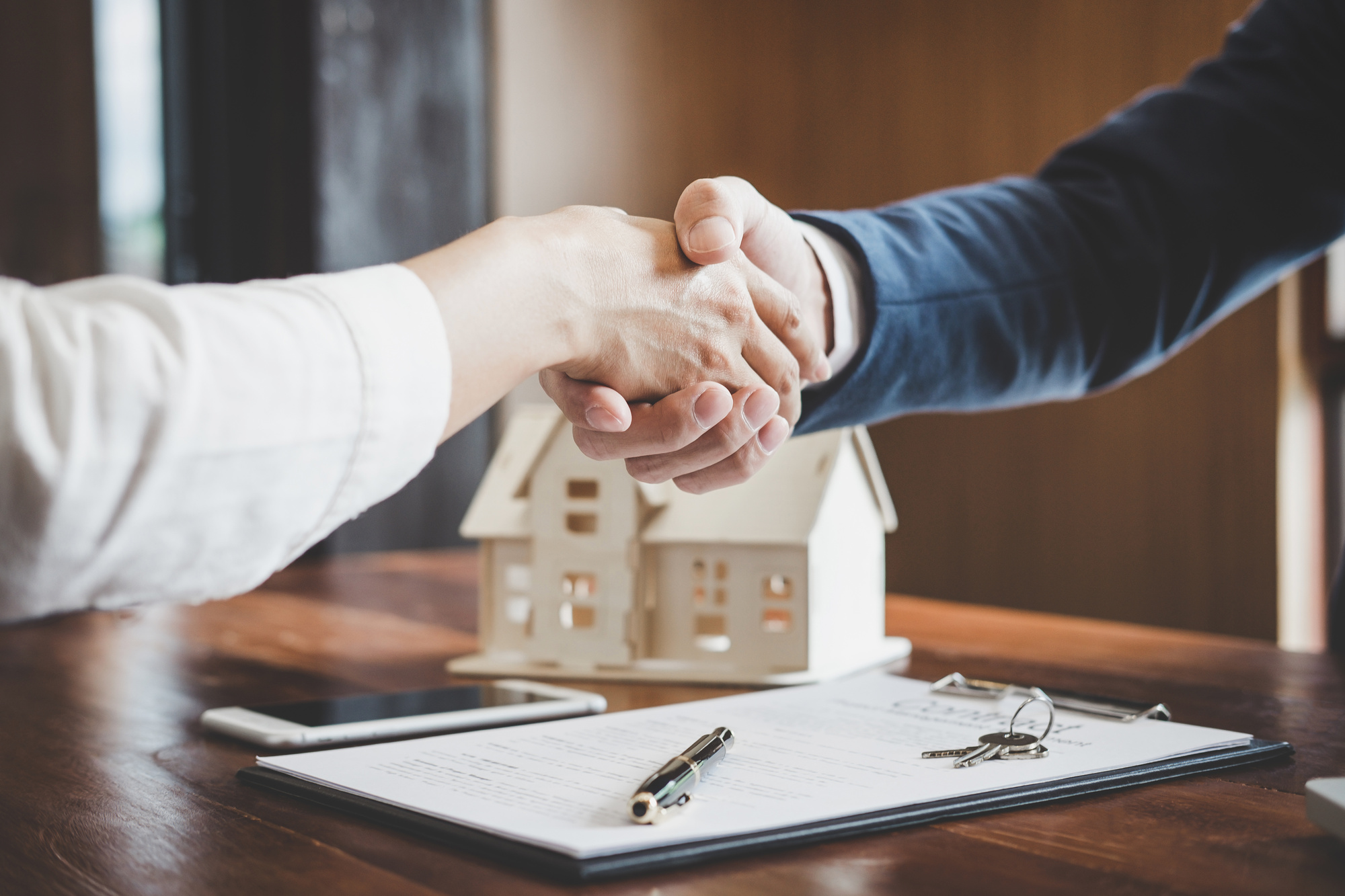 shaking hands after buying a home