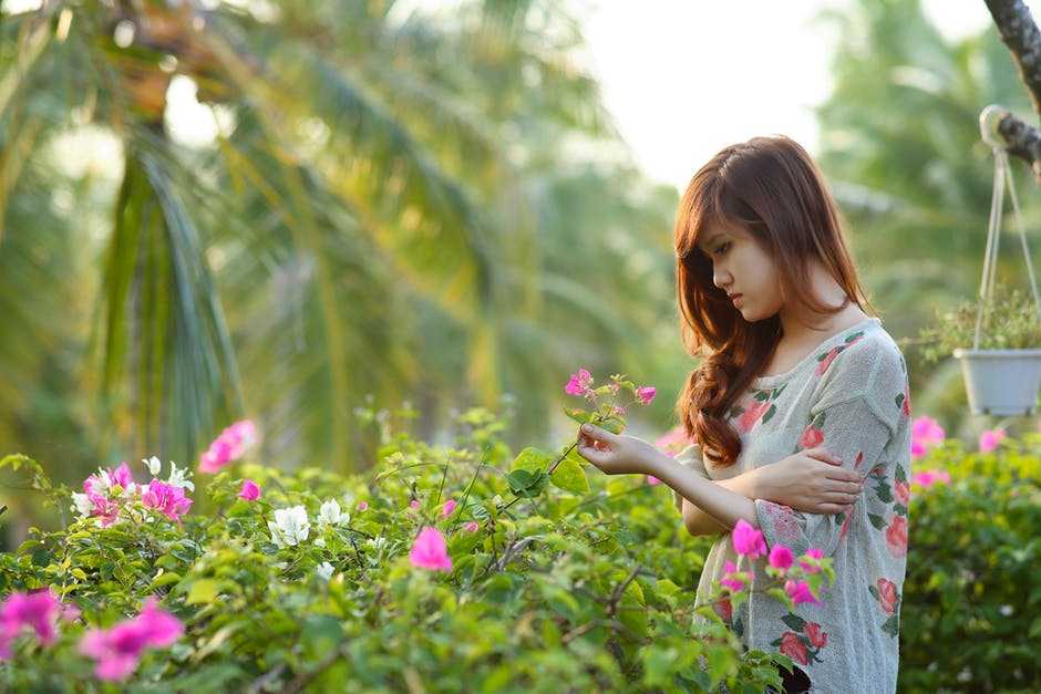 girl looking at flowers