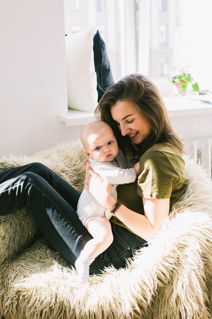 woman cuddling baby