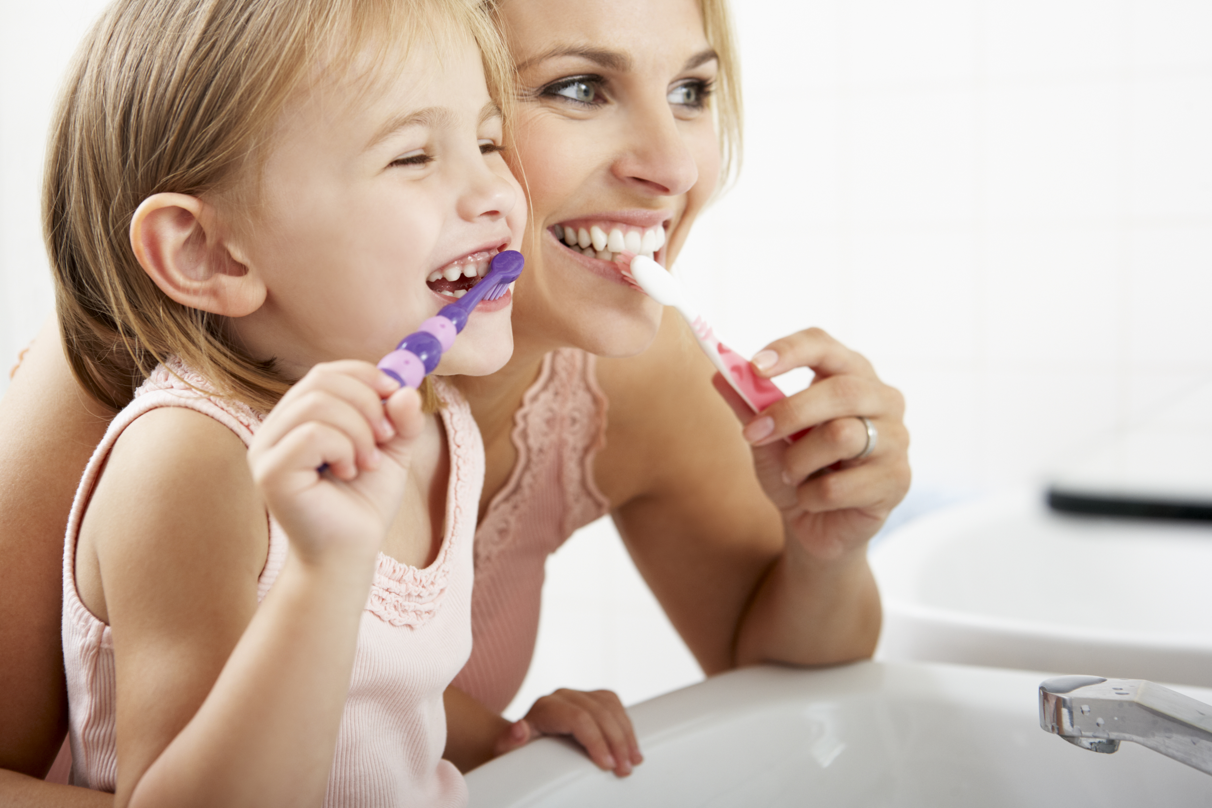 mom and kid brushing teeth