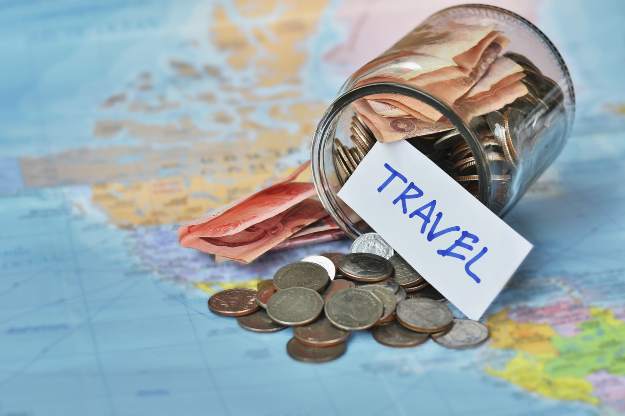 travel sign and money on map