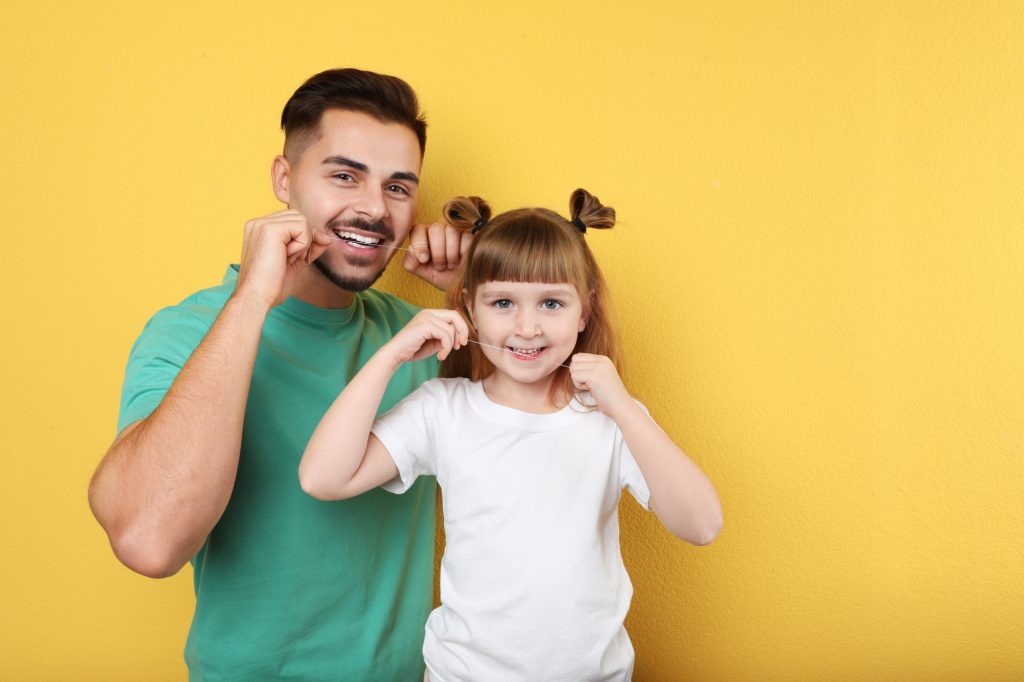 dad and kid flossing
