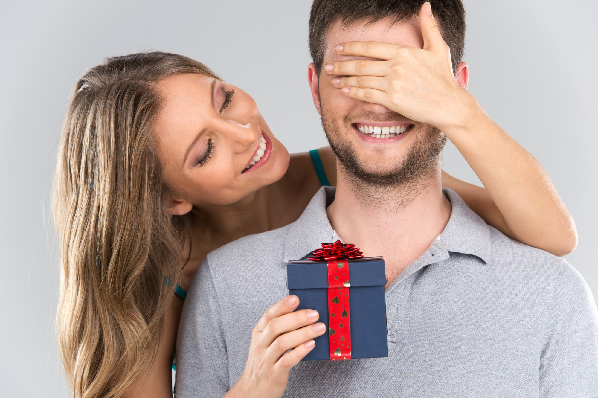 woman giving gift to boyfriend