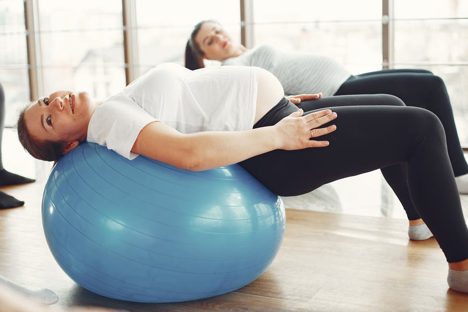 Pregnant Woman Doing Ball Stretching