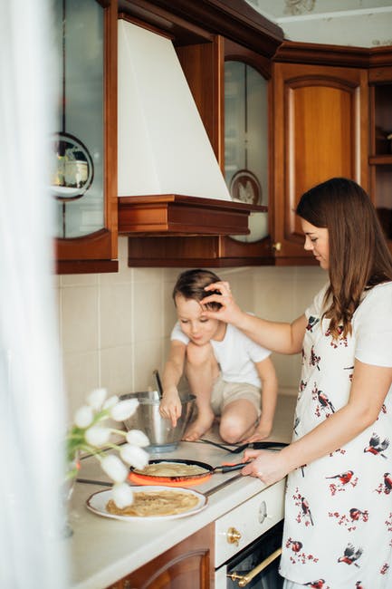 Single Mom with Her Child on the Kitchen